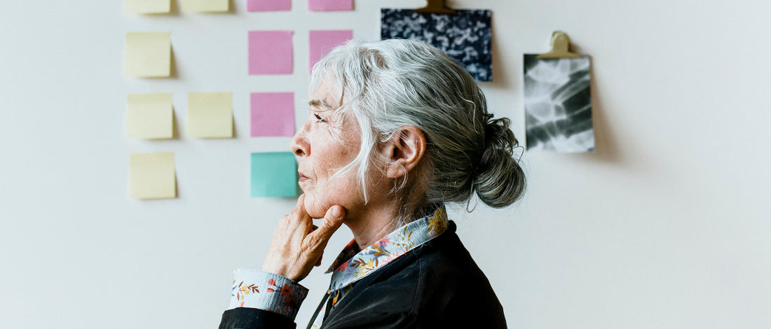 Lady with grey hair contemplating